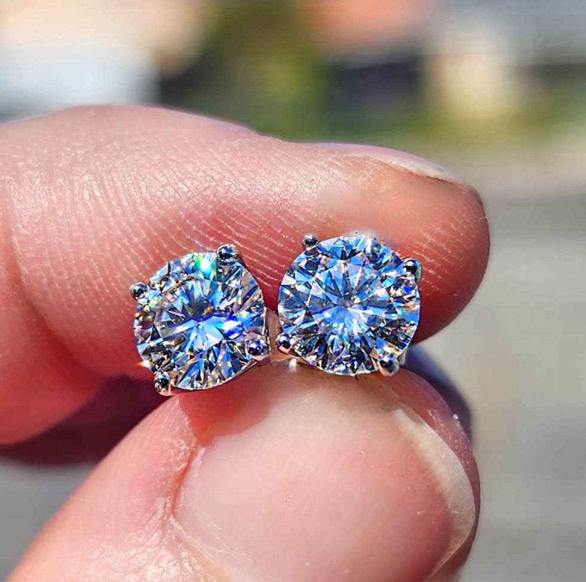 2 Carat Moissanite Round 18kt White Gold Plated Sterling Silver Stud Earrings.